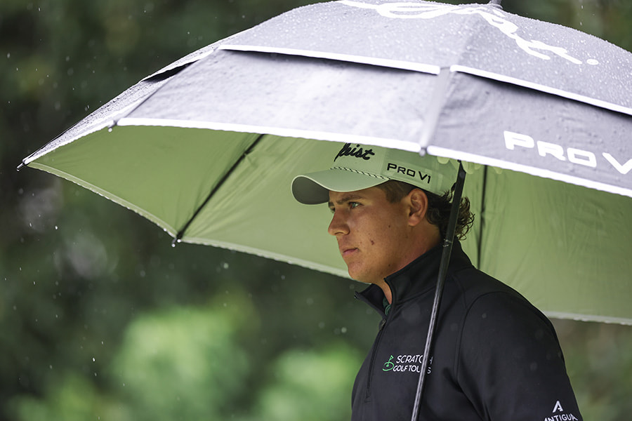 Aldrich Potgieter shelters from the rain at the 2025 Alferd Dunhill Championship